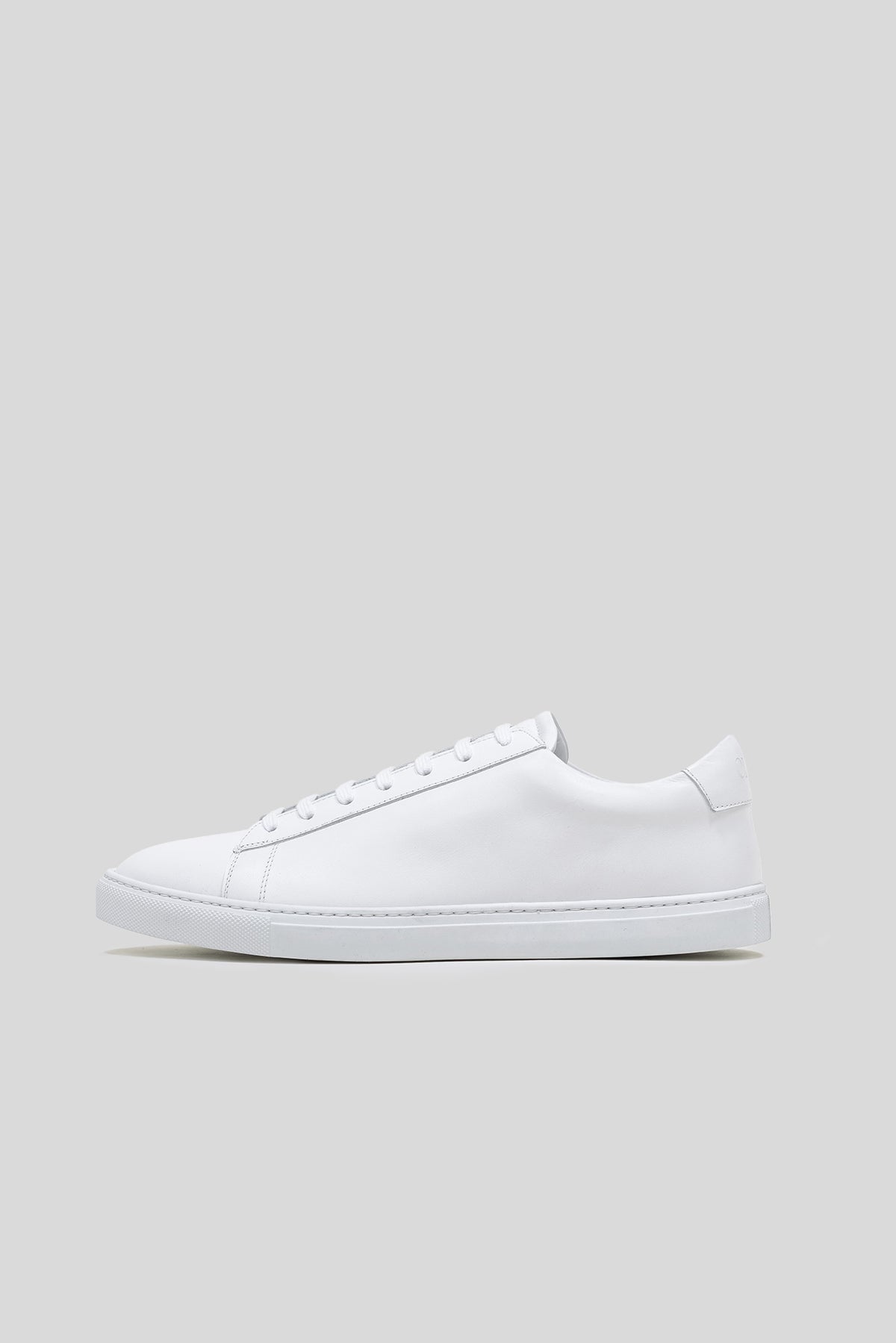 White Calfskin Città Sneaker, side profile showing the clean low-top silhouette and thin sole