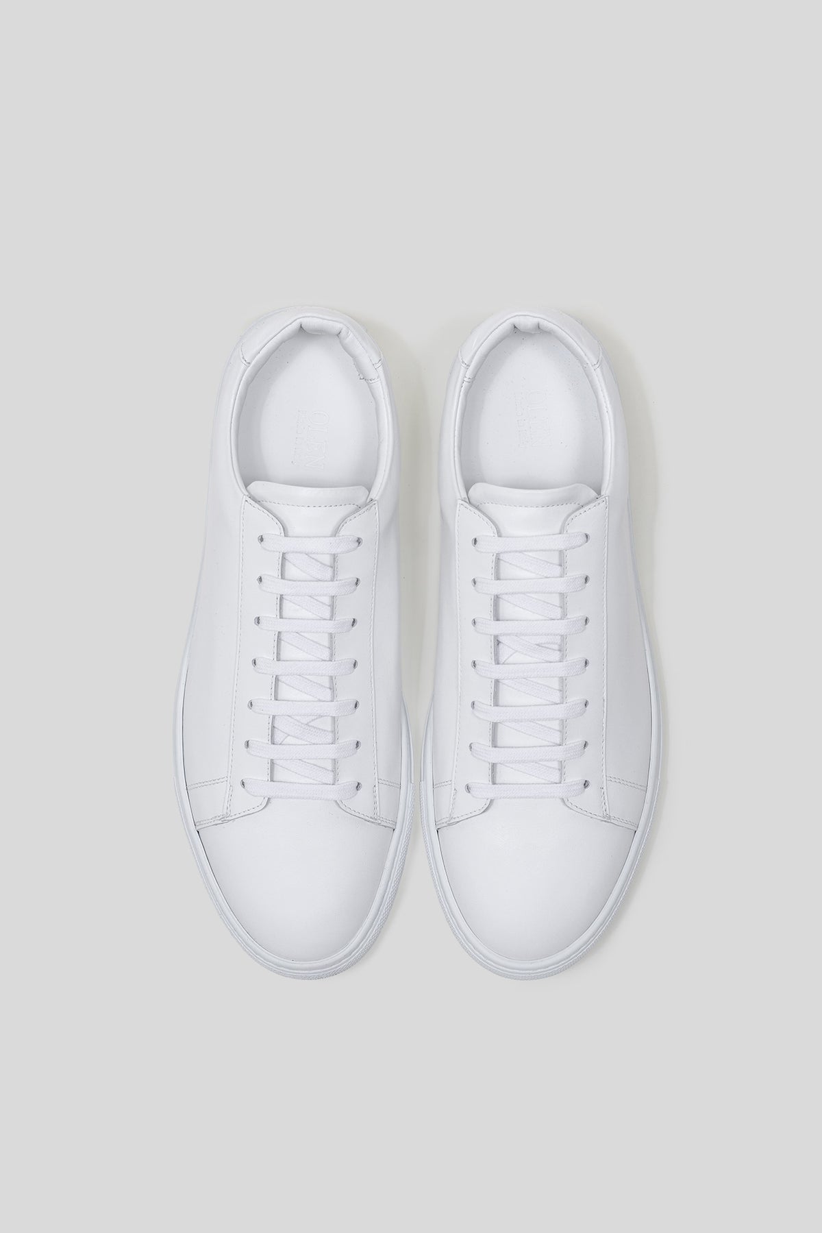 White Calfskin Città Sneaker, top view of the pair showing the lacing, cap toe and smooth calfskin