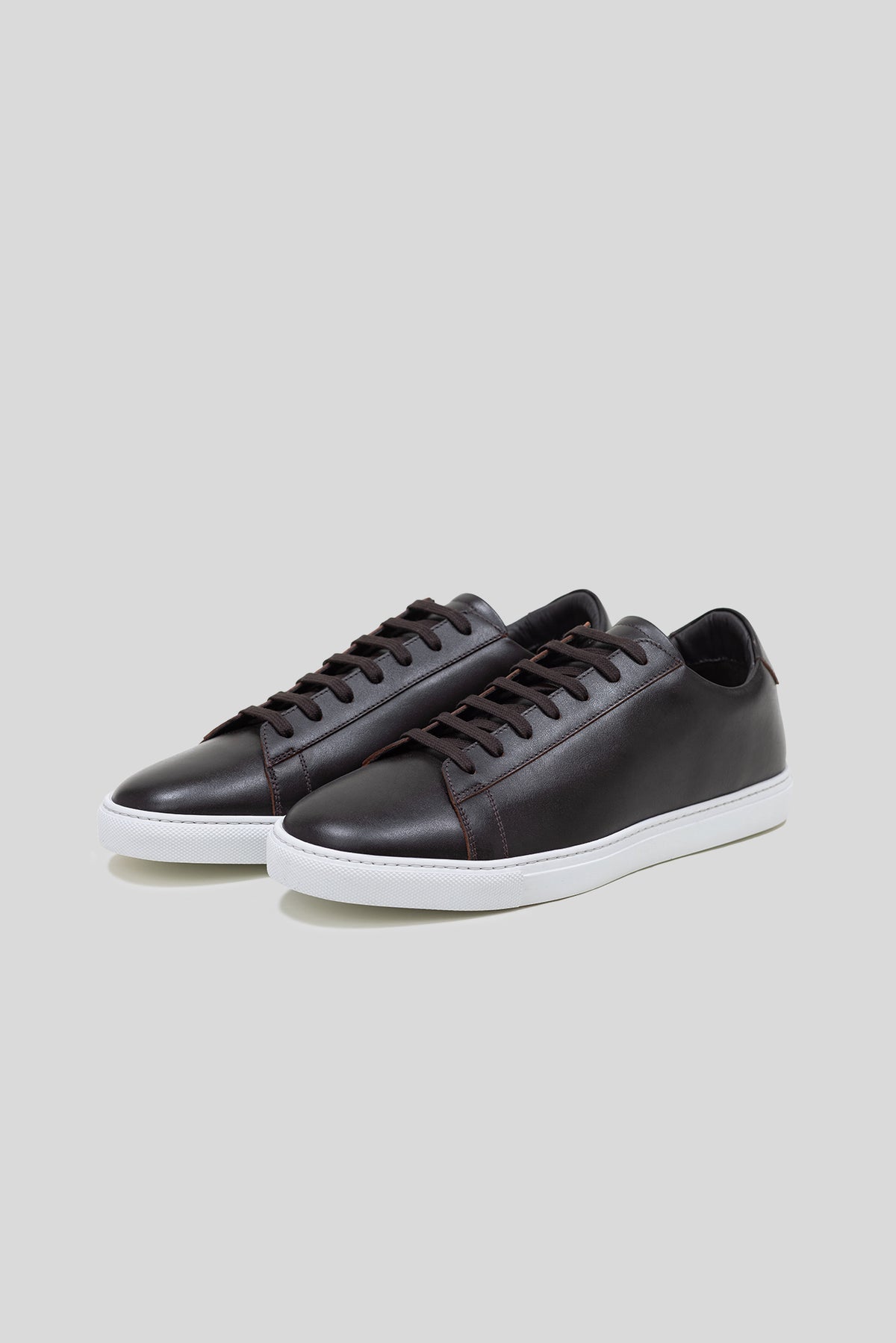 Pair of Olen dark brown calfskin Città sneakers with white rubber soles.