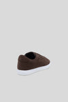Heel view of Olen dark brown suede Città sneaker showing embossed logo detail.